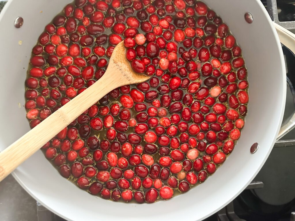Cranberries simmering in a pot. 