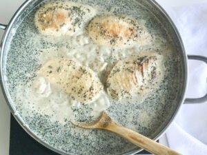chicken breasts added to roux in a pot