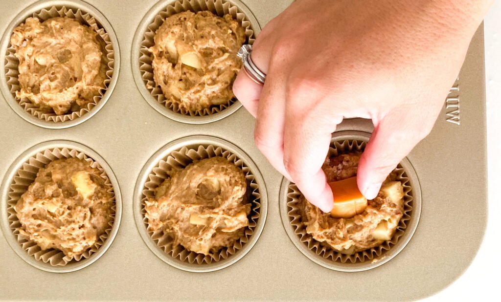 Apple muffins with caramels going in the middle.