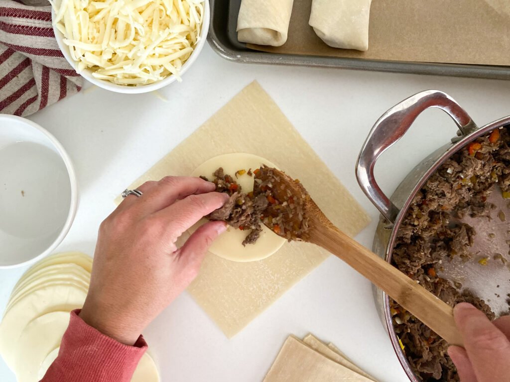 Philly cheesesteak egg rolls - process - filling the wrap