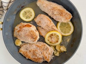 Browned chicken with smashed garlic and lemon slices