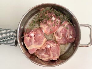 Cooking chicken thighs on the stove top.