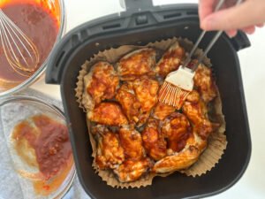 air fryer chicken wings with a sweet and spicy harissa sauce