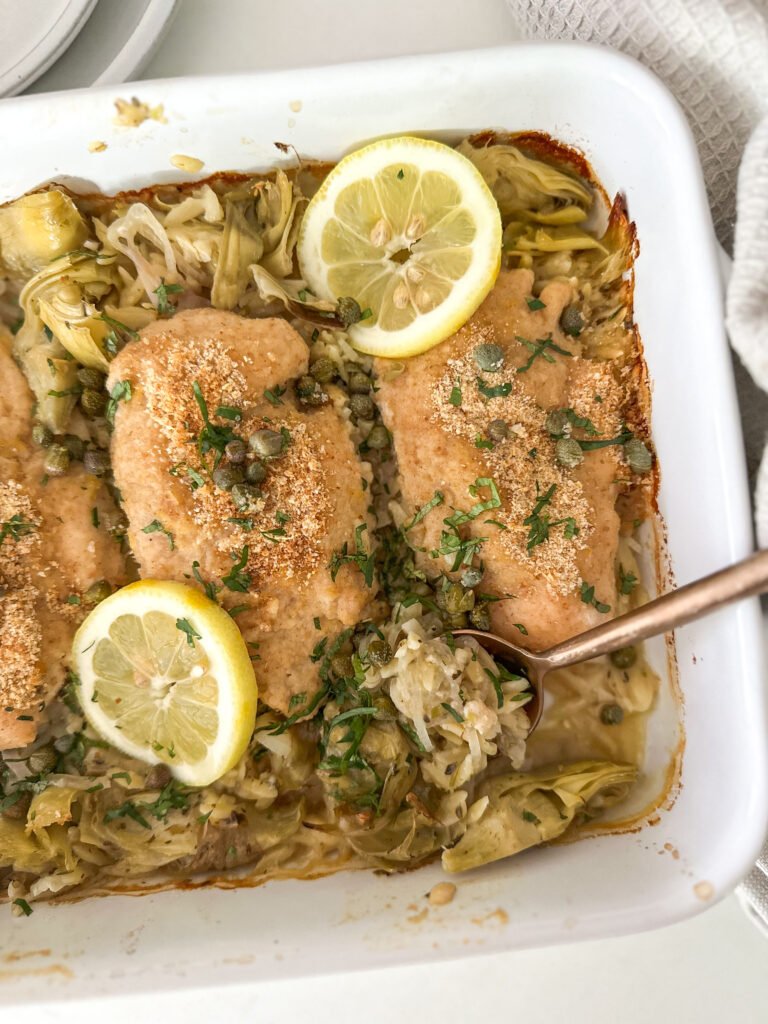 Close-up of a one-pan Lemon Chicken Piccata Artichoke Orzo Bake scooped out