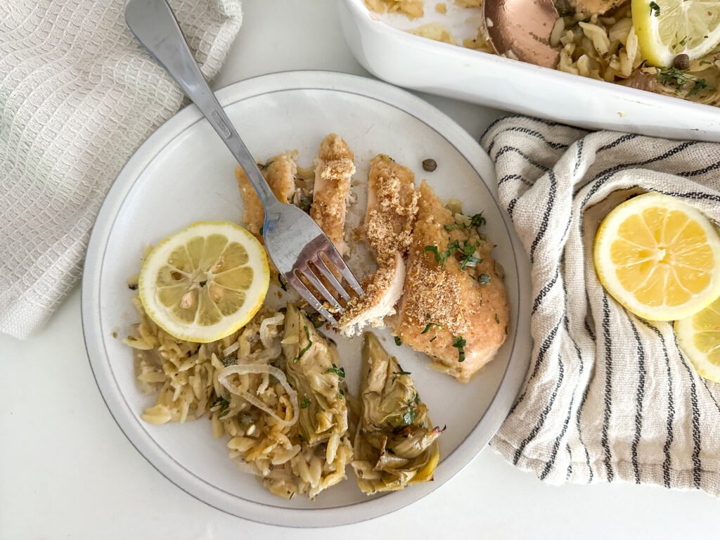 One-Pan Lemon Chicken Piccata Artichoke Orzo Bake scooped out and plated