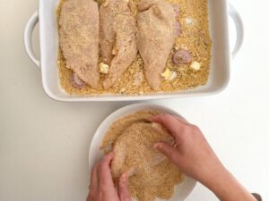 Add the lemon zest breadcrumbs to the chicken