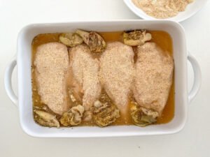 Add the artichoke hearts and chicken stock