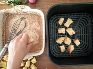 Putting the French toast pieces into the air-fryer.