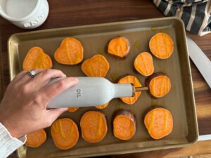 Sheet-Pan Candied Sweet Potatoes - prep, drizzle olive oil and sprinkle salt.