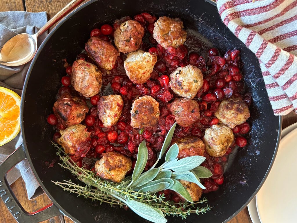 Herby Turkey Meatballs smothered in a Cranberry Orange Sauce.