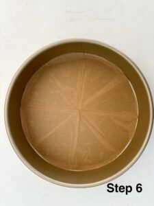 6. Open the parchment paper, it should fit the bottom of the cake pan. It's okay if it's a little smaller.