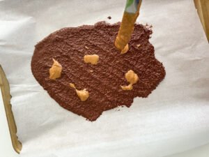 Dollops of peanut butter on the popped quinoa chocolate bark