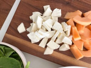Prep for the spinach salad, cut cantelope and fresh mozzarella.