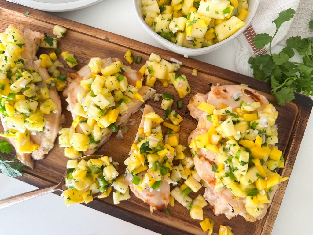 Fresh pineapple and mango salsa topped on grilled chicken. 