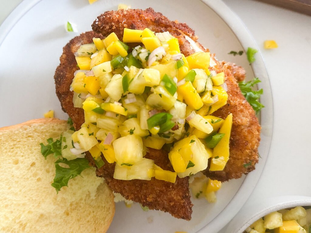 Fried chicken topped with fresh pineapple mango salsa 