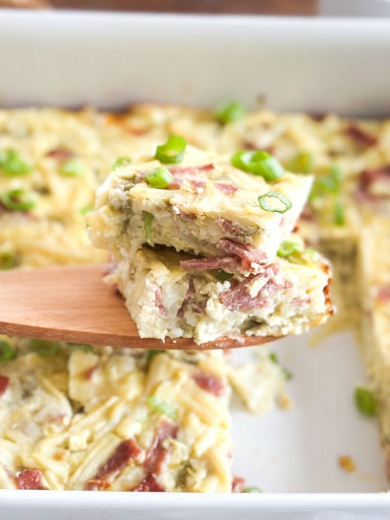 Up close cut out of the layers of egg, bacon, hash brown and melted cheese. 