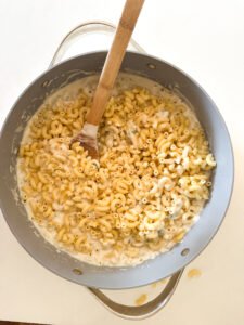 Add pasta into the white sauce to make the mac and cheese