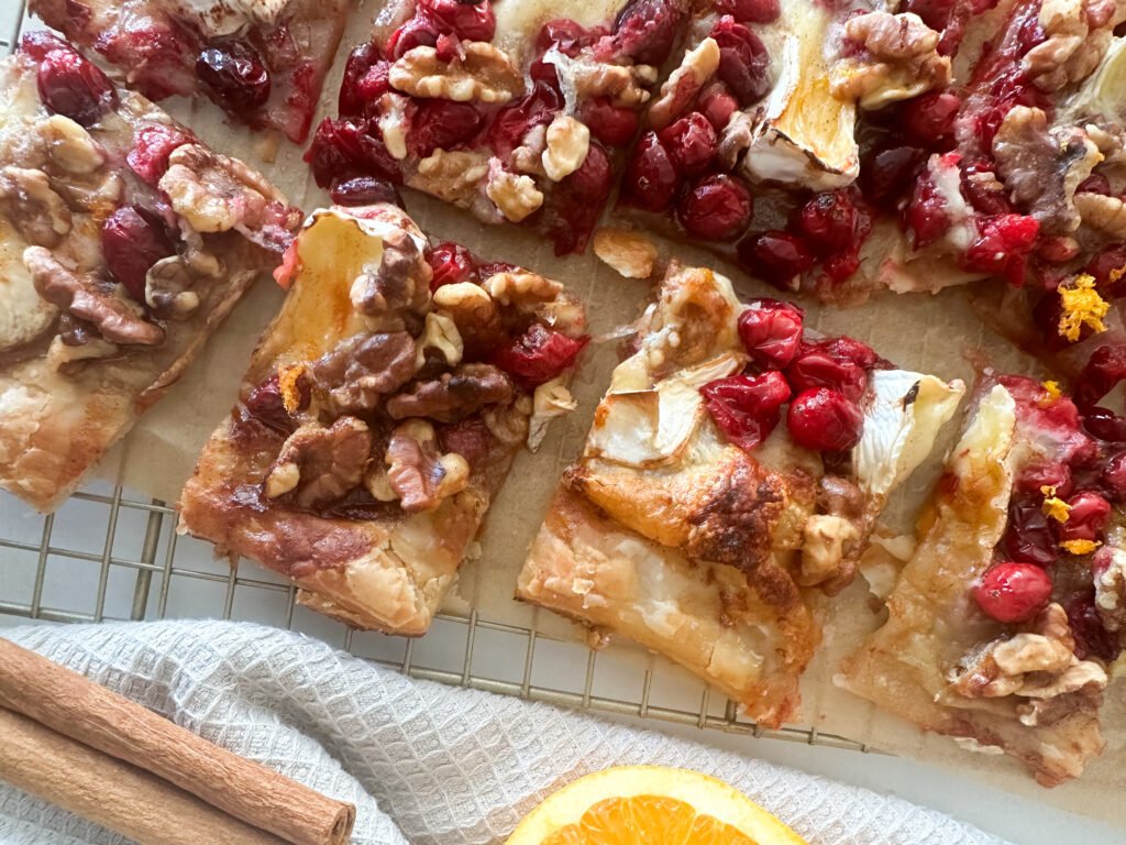 Sweet Holiday Cranberry Brie Tart - cut up close with garnishes